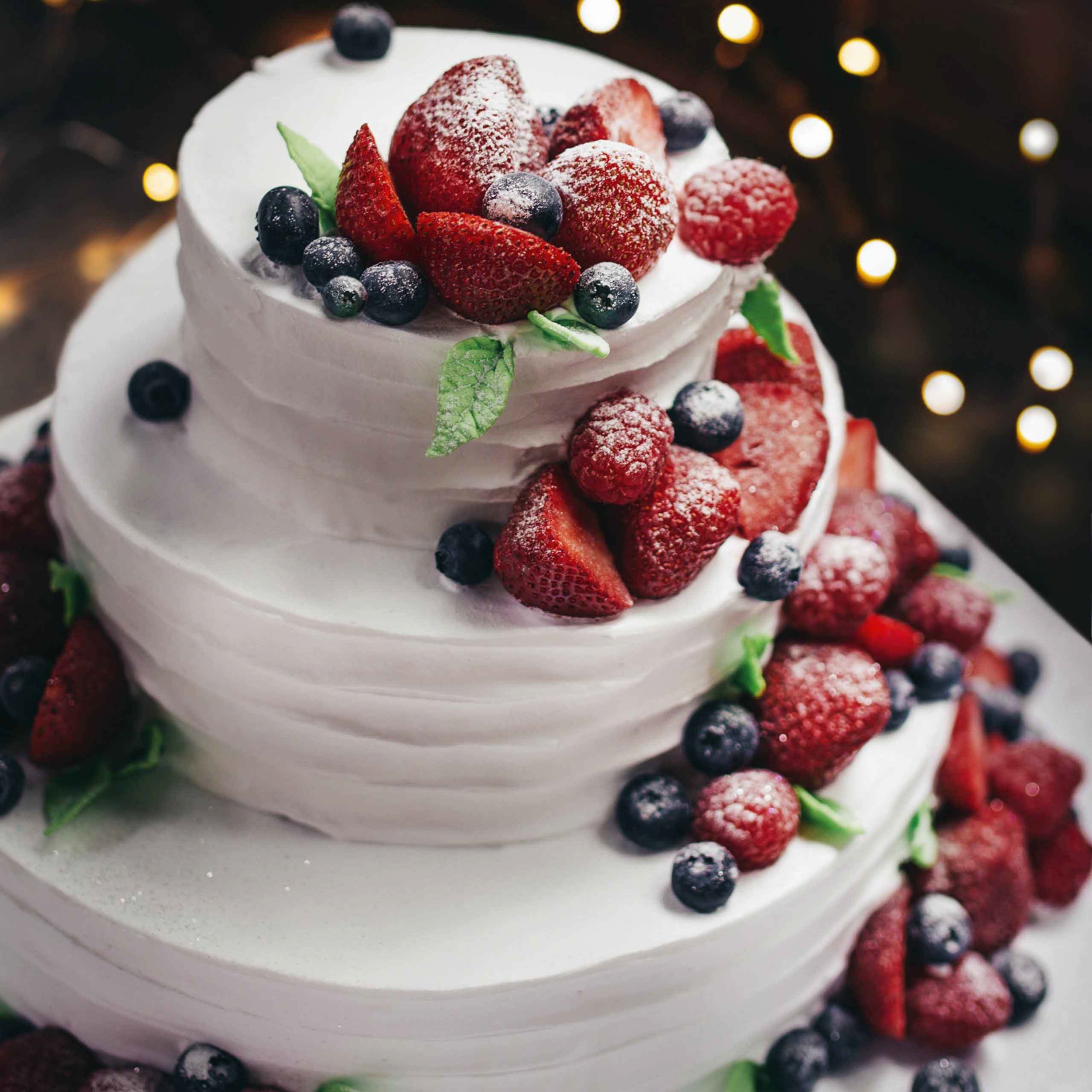 white cake with berry decorations
